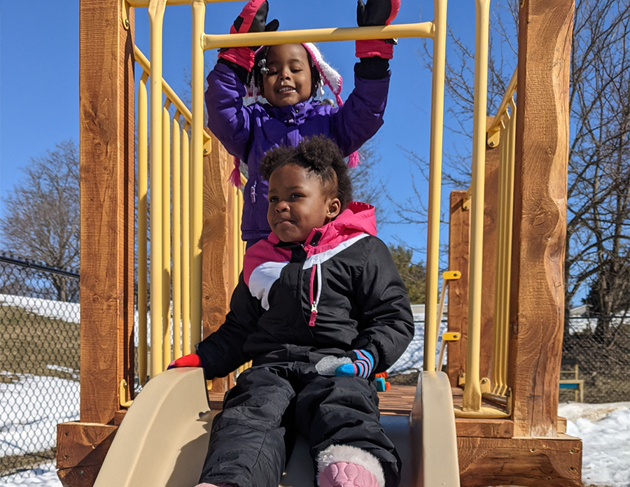 Two children on a slide
